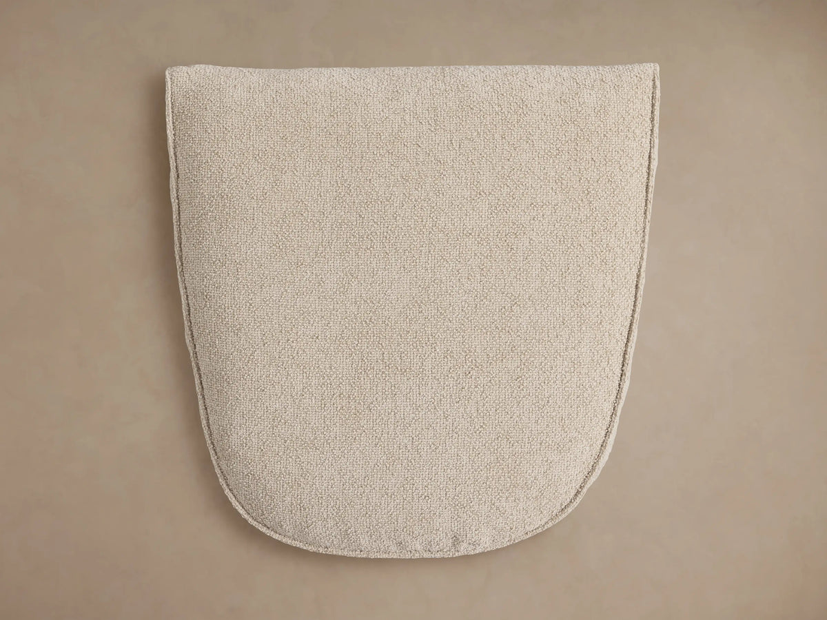 Close-up of a Giorgio Ottoman's light beige Abi Fawn Performance Fabric, showing its soft, textured surface and stitched edges.