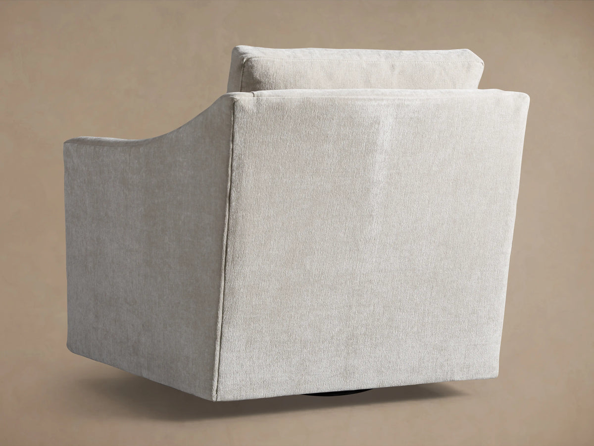 Branson Swivel Chair in side view, showcasing its neutral fabric upholstery and sleek, angular design on a tan background.
