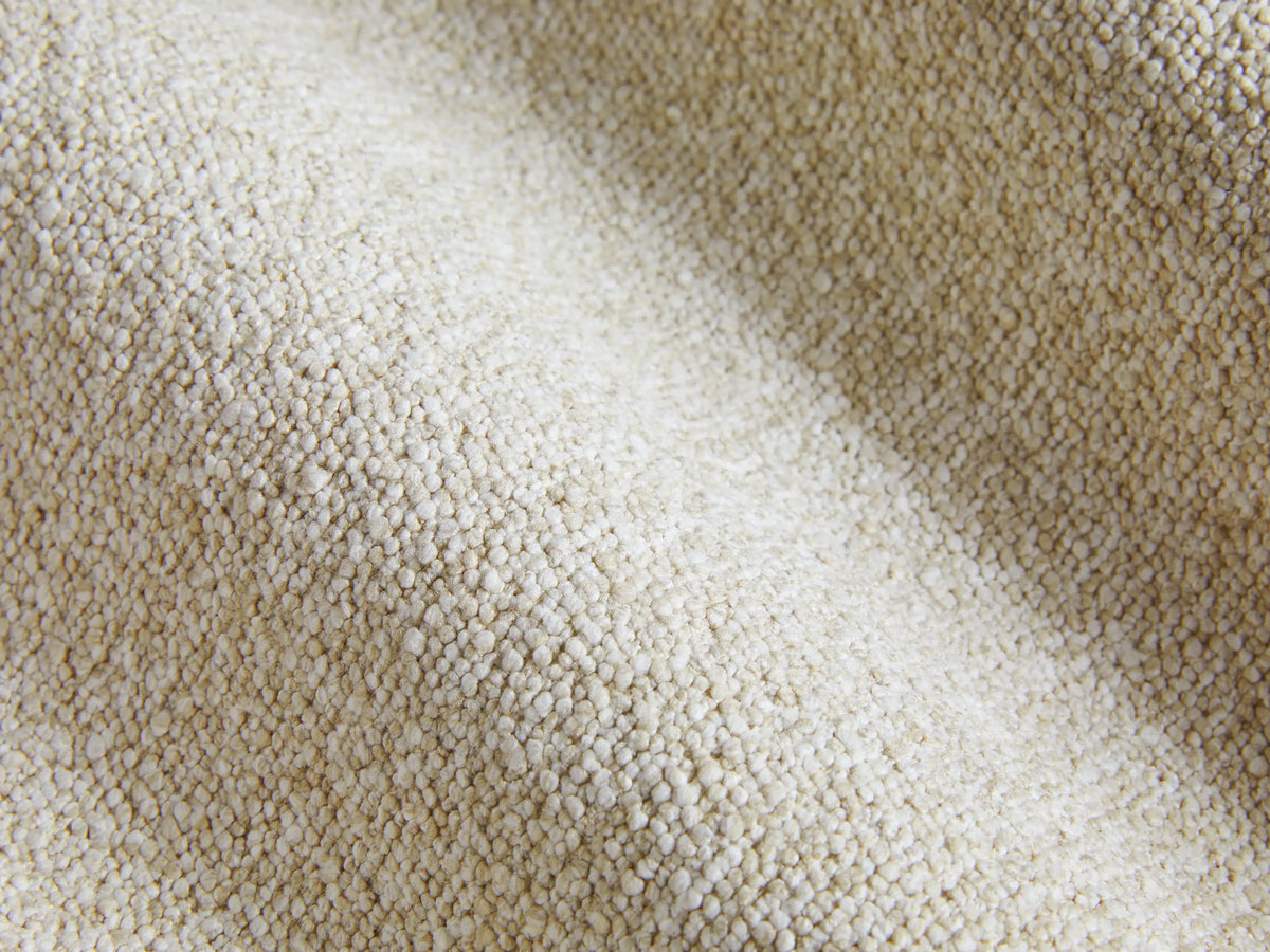 Creamy beige Brennan Motion Recliner, shown from a 3/4 view, with its footrest extended and backrest slightly reclined.
