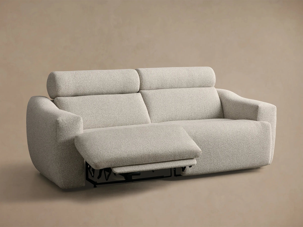 Front view of the pale gray textured Fia Two-Piece Motion Sofa, with the right footrest fully extended.