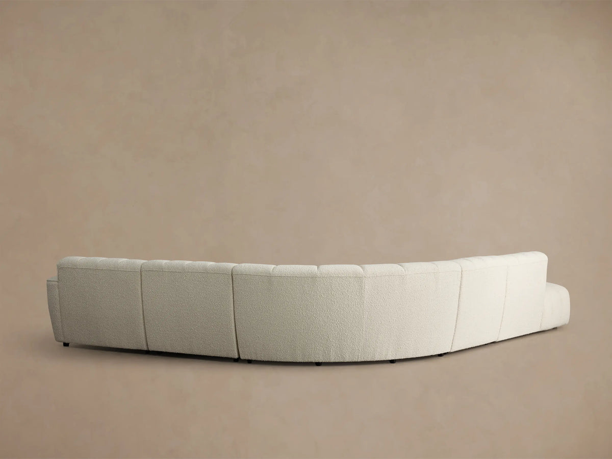 Close-up of the light beige boucle texture on the Bracco Five-Piece Bumper Sectional, showing vertical channel tufting.
