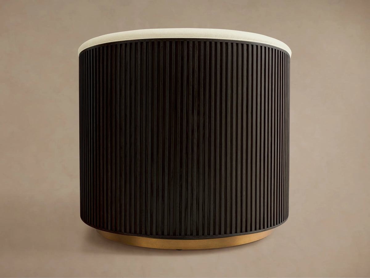 Finnley Swivel Chair in Ebony finish, featuring a curved, vertical slat design. Beige upholstery on the upper back, set on a wooden circular base.