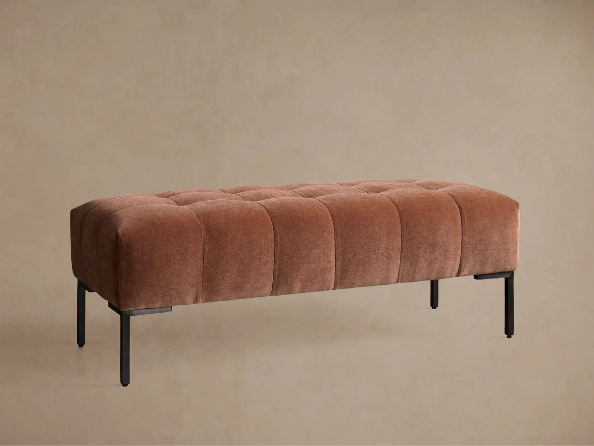 Angled close-up of a brown tufted upholstered Tilton Bench with sleek black metal legs.