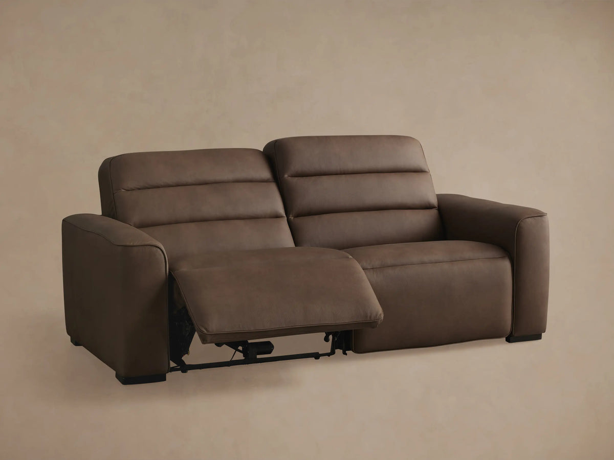 Borough Leather Two-Piece Motion Sofa, brown, right seat reclined with footrest extended, left seat upright.