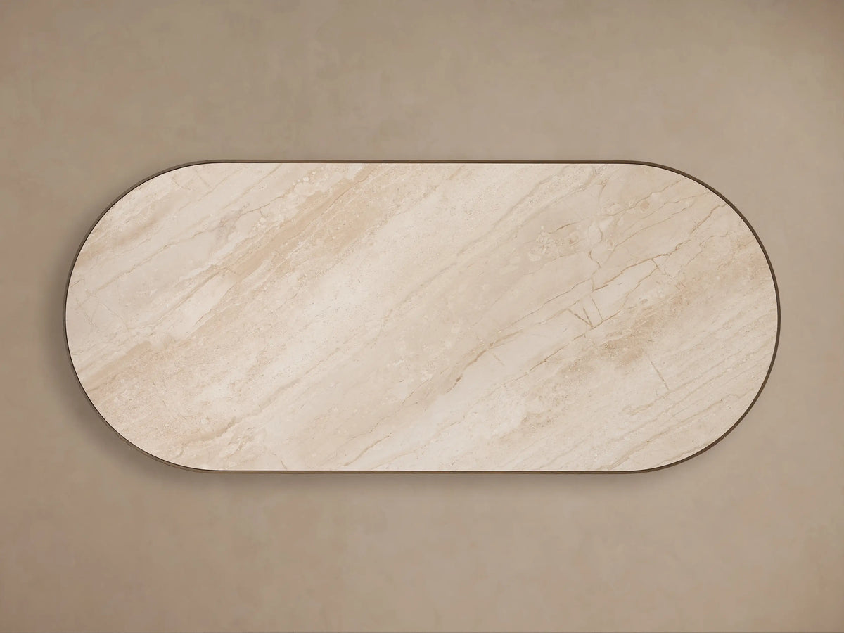 Astor Dining Table: close-up angled view showing light beige marble top, dark oak trim, and vertically reeded wood base.