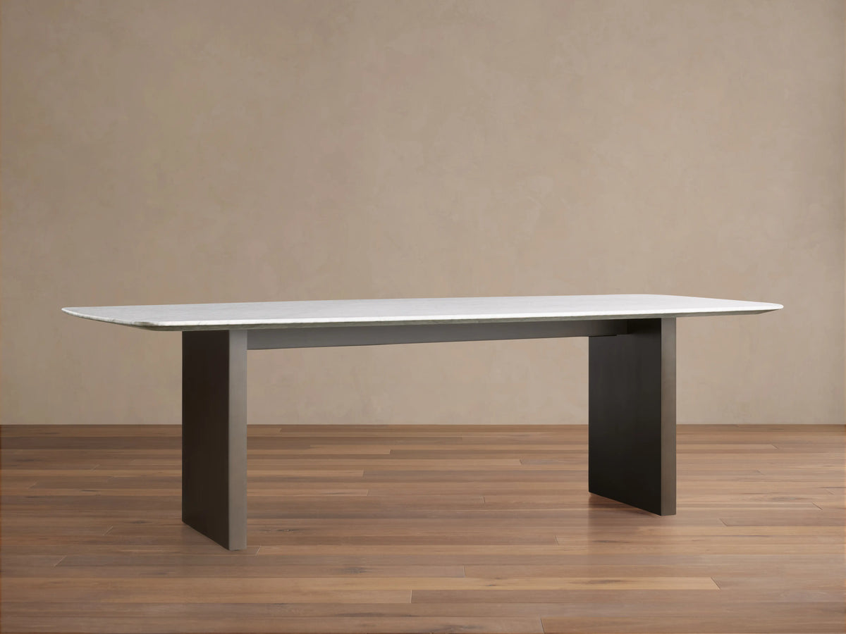 Alt text: Close-up of Saint Germain Stone Dining Table featuring a Carrara marble tabletop with visible natural veining.