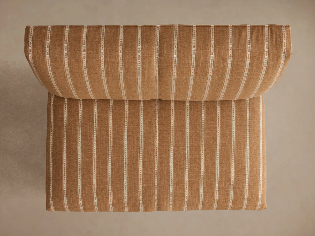 Eaton Bench, back 3/4 view, light brown fabric with thin white vertical stripes, dark tapered legs.