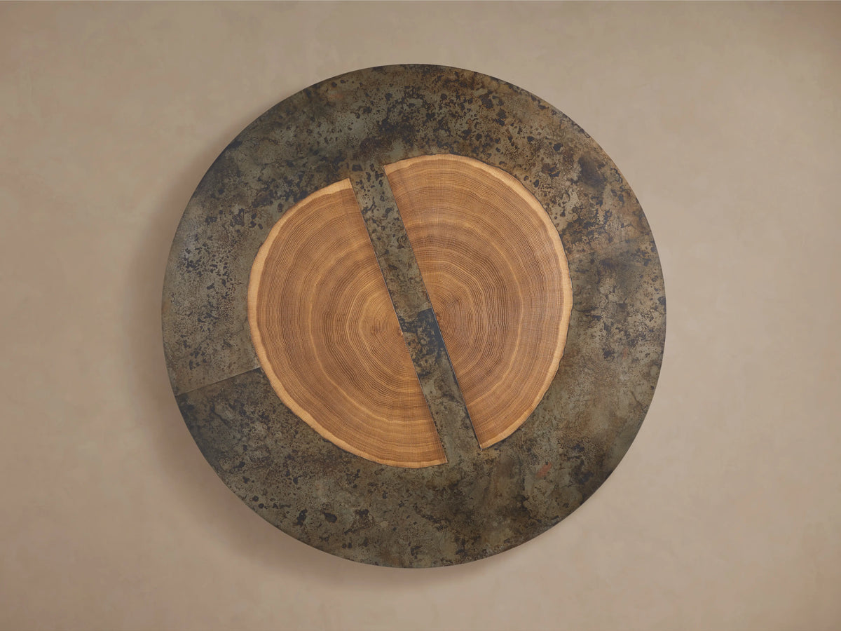 Close-up of the Acacius Round Coffee Table, featuring a top with natural wood grain patterns and oxidized steel edges in a weathered finish.