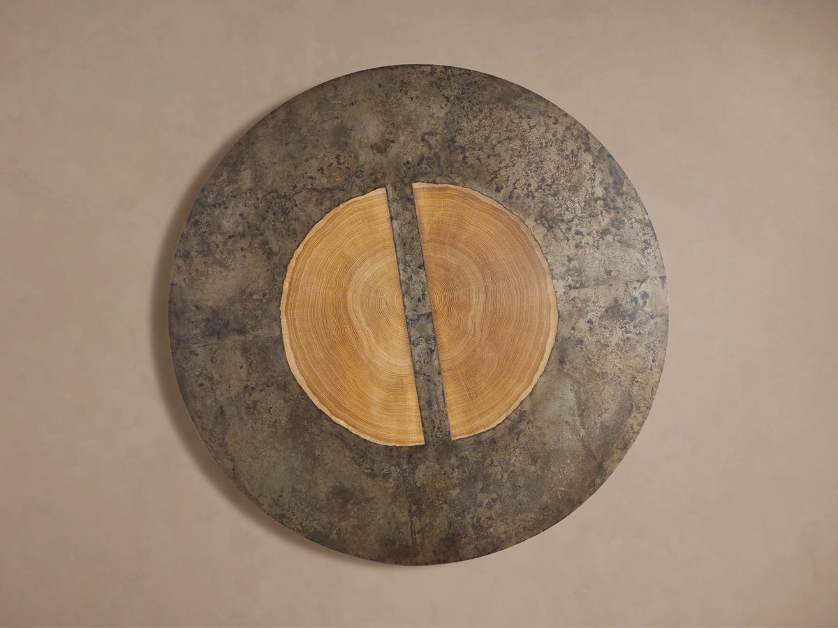 Acacius Round Coffee Table featuring a weathered steel surface, showcasing a unique textured pattern with reclaimed wood accents.