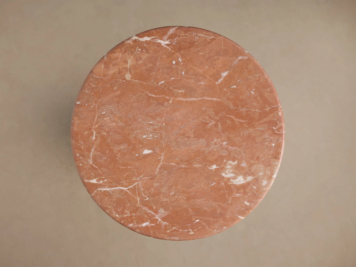 Close-up of the reddish-brown Brecken End Table's marble top and base, with distinct white veining.