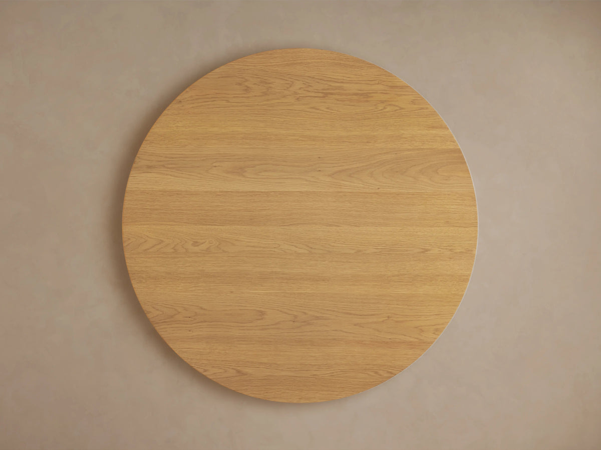 Finnley Round Wood Coffee Table in Honey finish showing a smooth round top and vertically slatted wood sides in light oak.