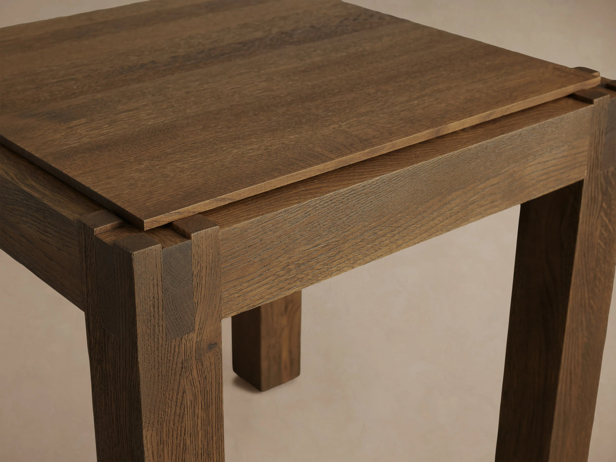 Harlan End Table made of solid oak with a square top and sturdy legs. Features natural wood grain and lacquer sheen.