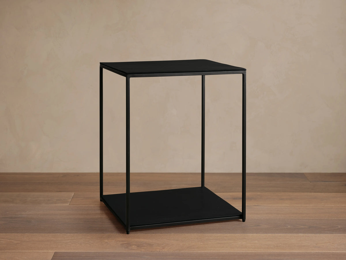 Kavali Square End Table with a sleek black aluminum surface and slim iron frame, featuring a powder-coated finish.
