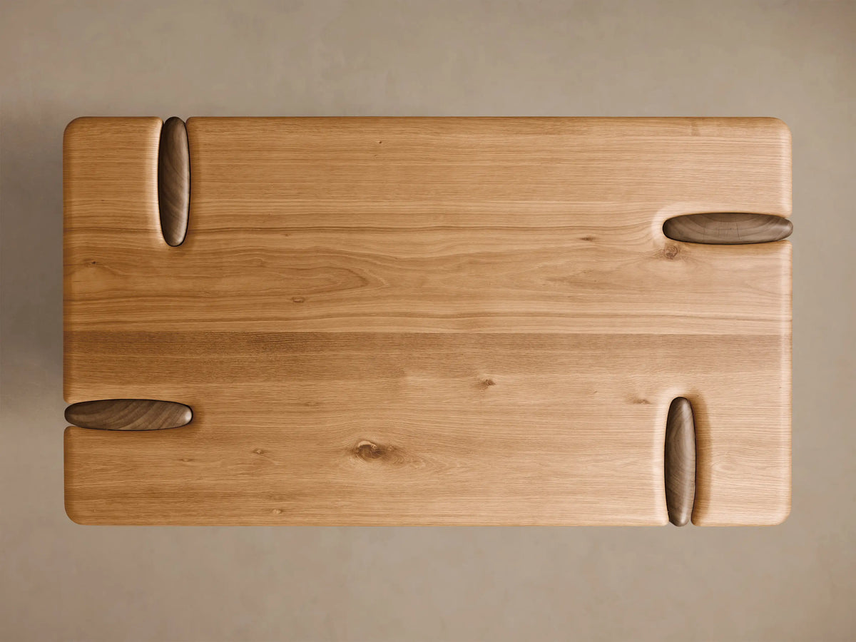 Close-up of the light brown Flowing Oak Tiered Table, showing smooth, rounded tiers and the seamless carved wood connection.