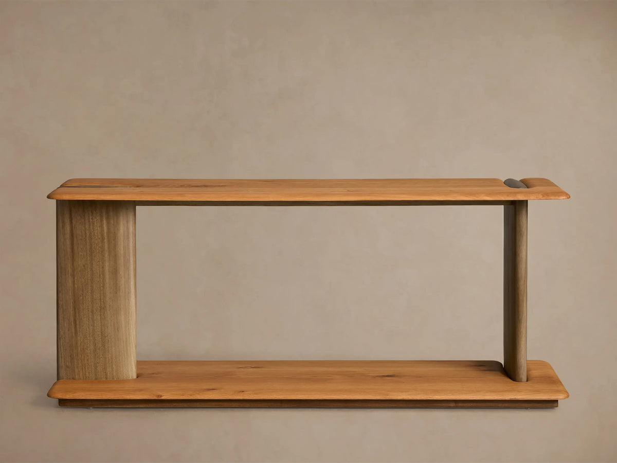 Front view of the light and medium brown wood Nolito Console Table with a rounded silhouette, beveled edges, and curved supports.