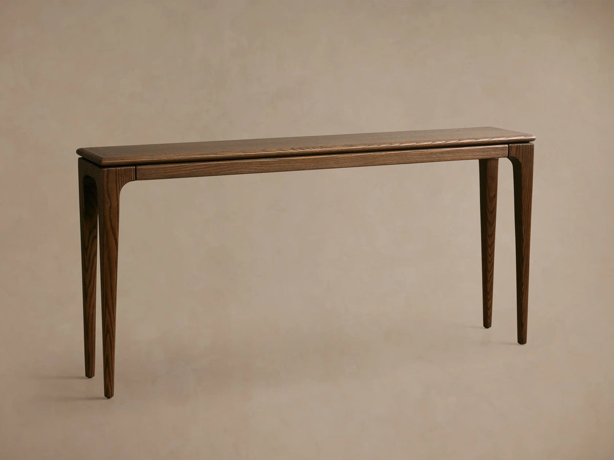Close-up, angled view of a Park Console Table with a rich mocha wood finish, showing its distinct grain and curved leg detail.