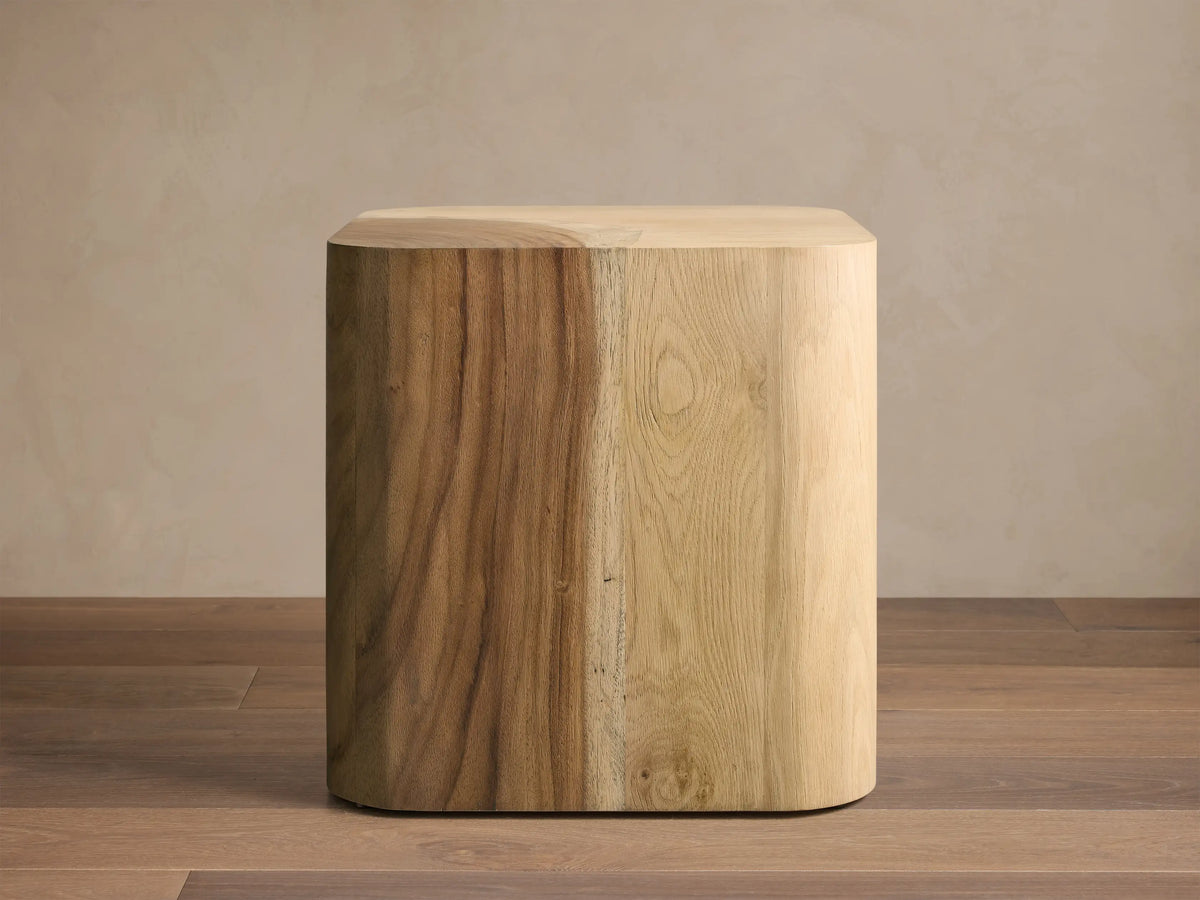 Close-up of the Ramiro End Table, showing the rounded corner with a curved inlay of lighter American oak and darker Guanacaste wood.