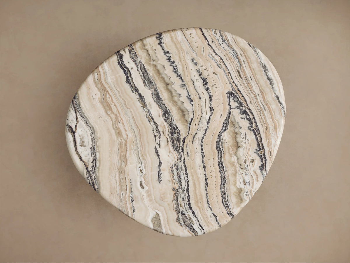 Rune End Table with a polished, round marble top featuring intricate beige and brown veining, supported by thick, carved wooden legs.