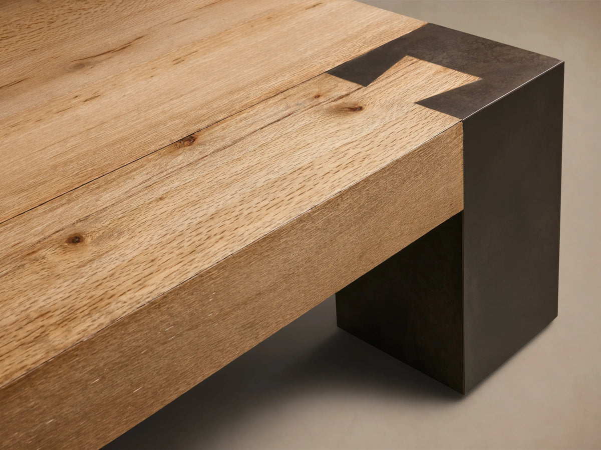 Top-down view of the Telluride Square Coffee Table, featuring a light natural oak wood surface with dark oxidized steel corner accents.