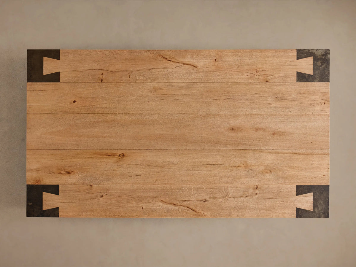 Top-down view of the light brown Telluride Coffee Table, featuring natural oak wood planks and four dark oxidized steel corner accents.