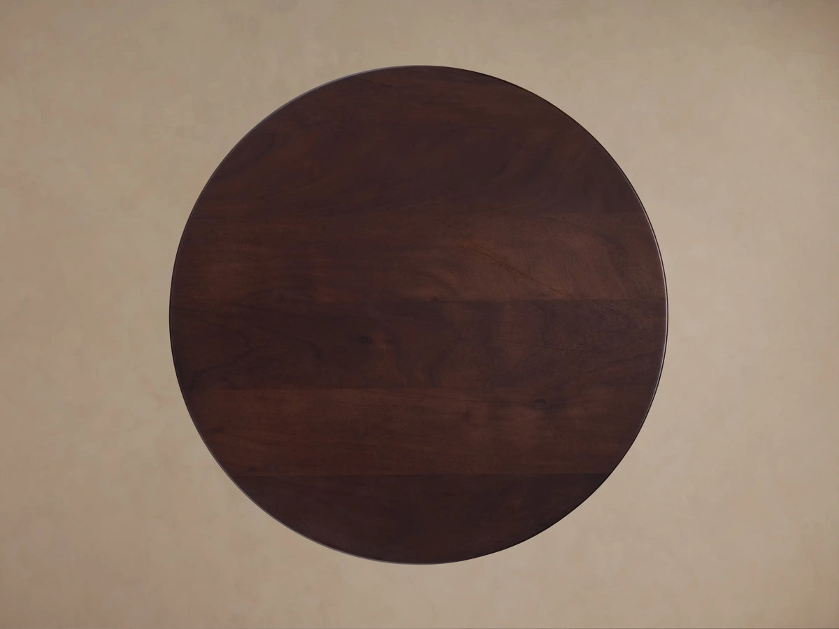 Top view of the dark brown wooden circular tabletop of the Volant Leather End Table.