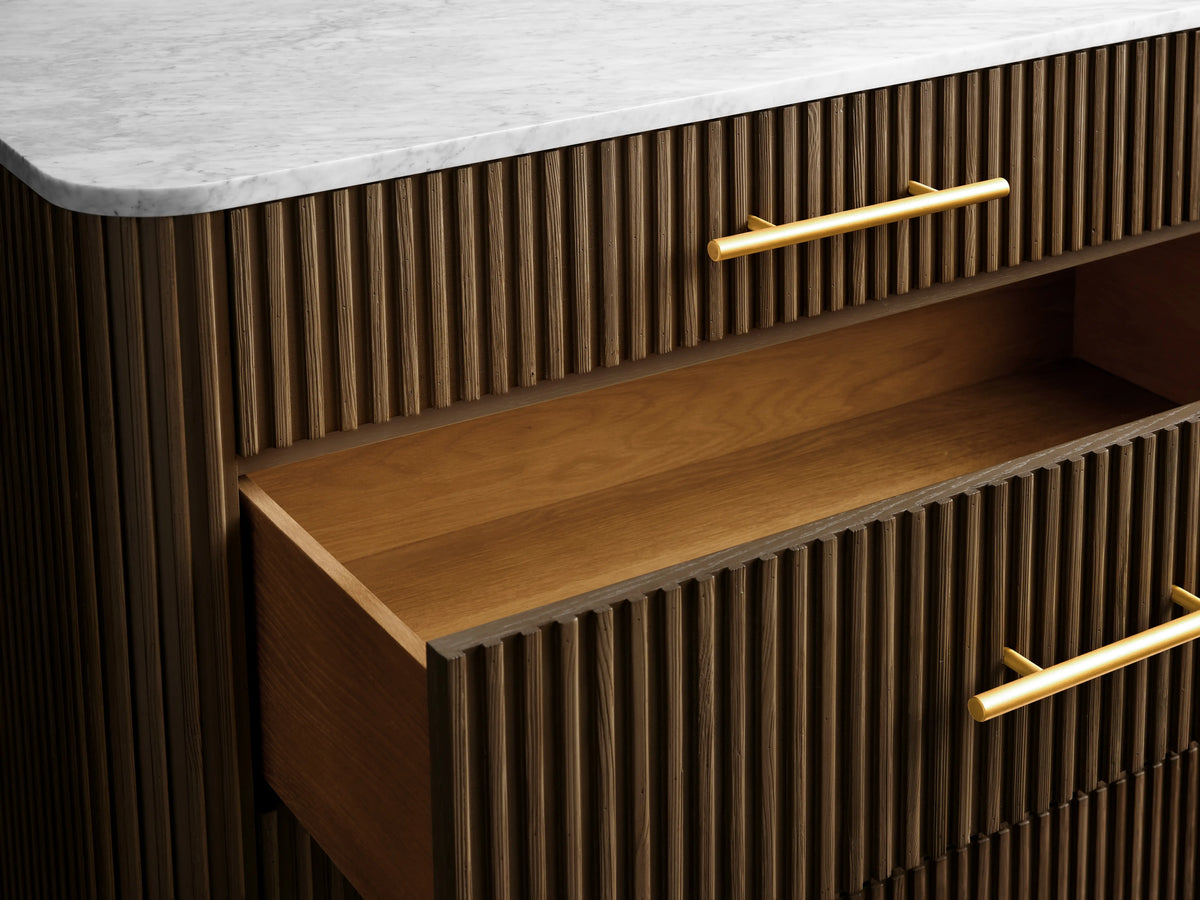 Finnley Five-Drawer Dresser with vertical grooves, brass-finished handles, two open drawers, and a marble top on slender legs.