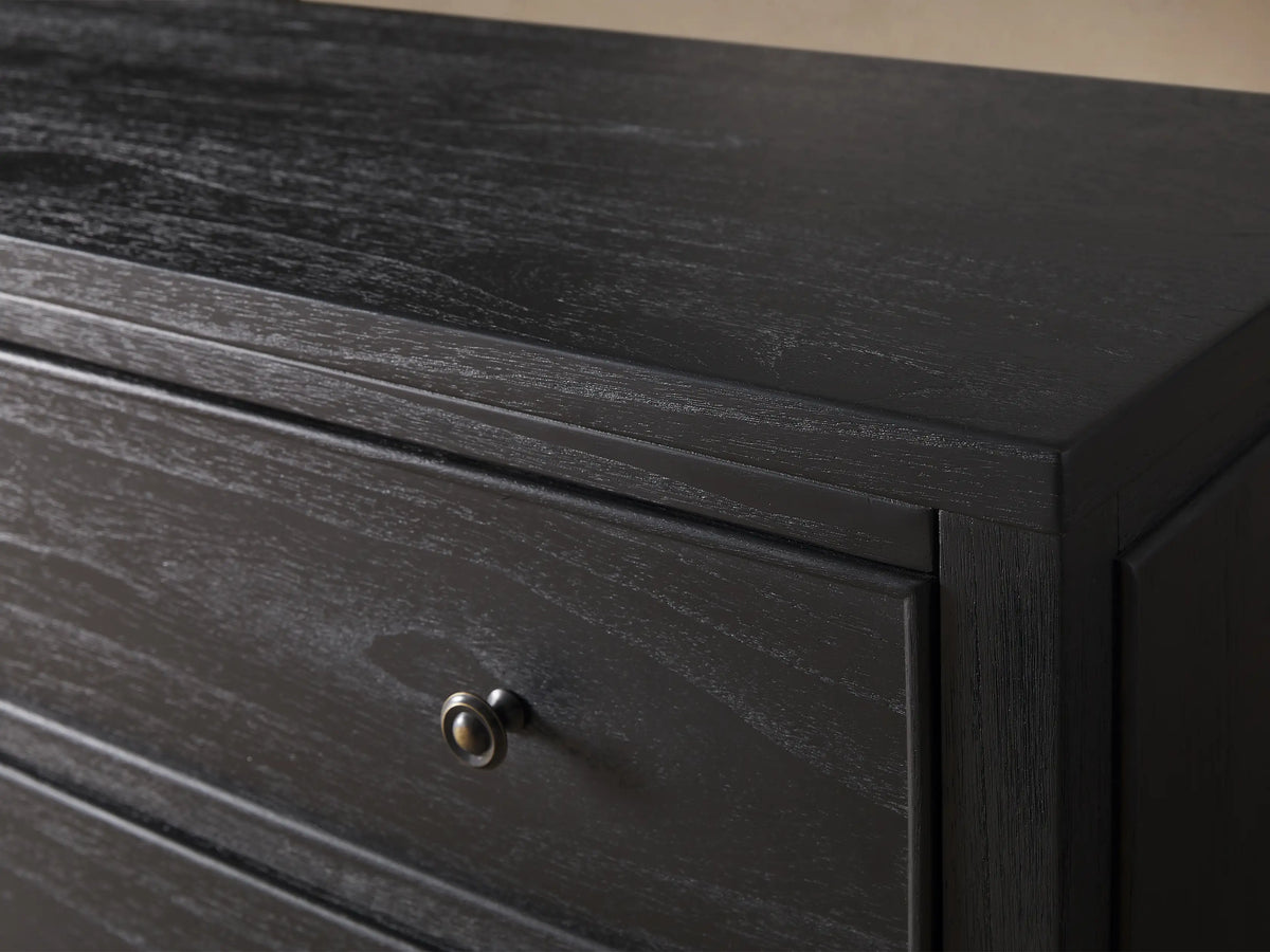 Pearson Wide Six-Drawer Dresser in dark gray mindi wood, with six framed drawers and dark round knobs, against a beige wall.