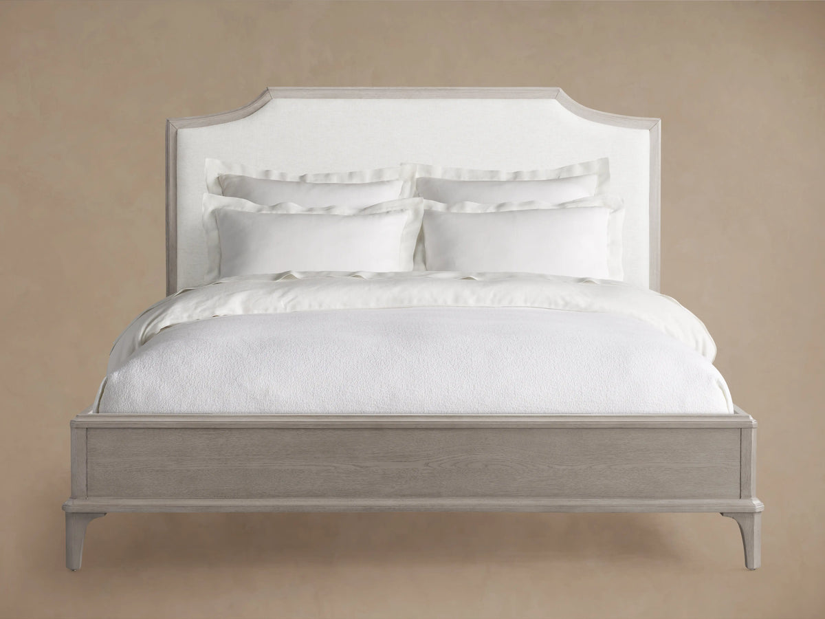 Curved oak wood headboard with a soft beige fabric panel, showcasing craftsmanship and a modern design.