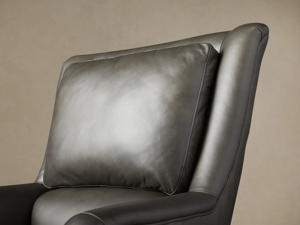 Dark grey leather Alex Desk Chair, angled right. High back, plush seat, rolled arms, 5-wheel caster base.