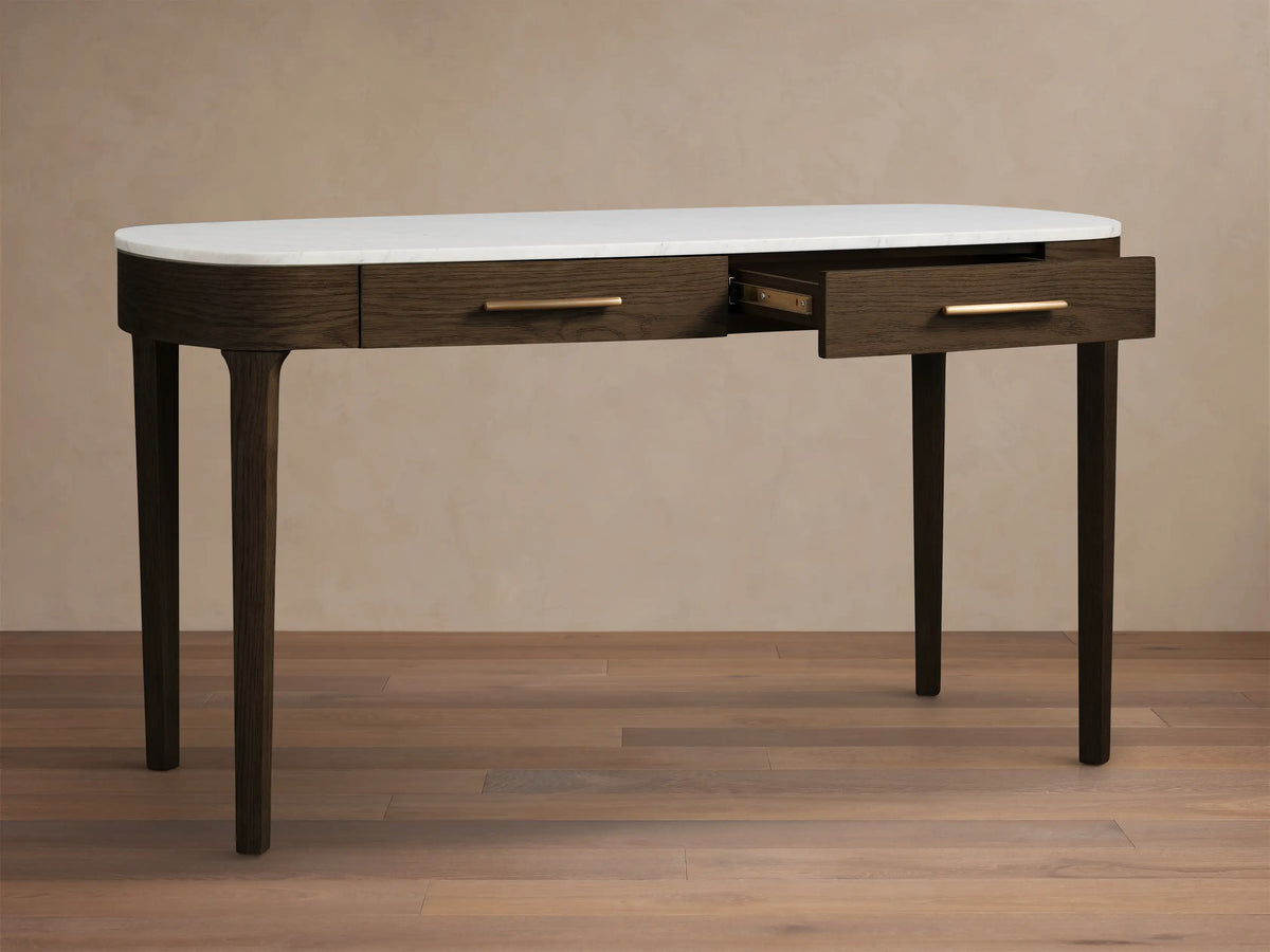 Front view of the dark oak Danny Writing Desk featuring a white Carrara marble top, two subtle drawers, and tapered legs.