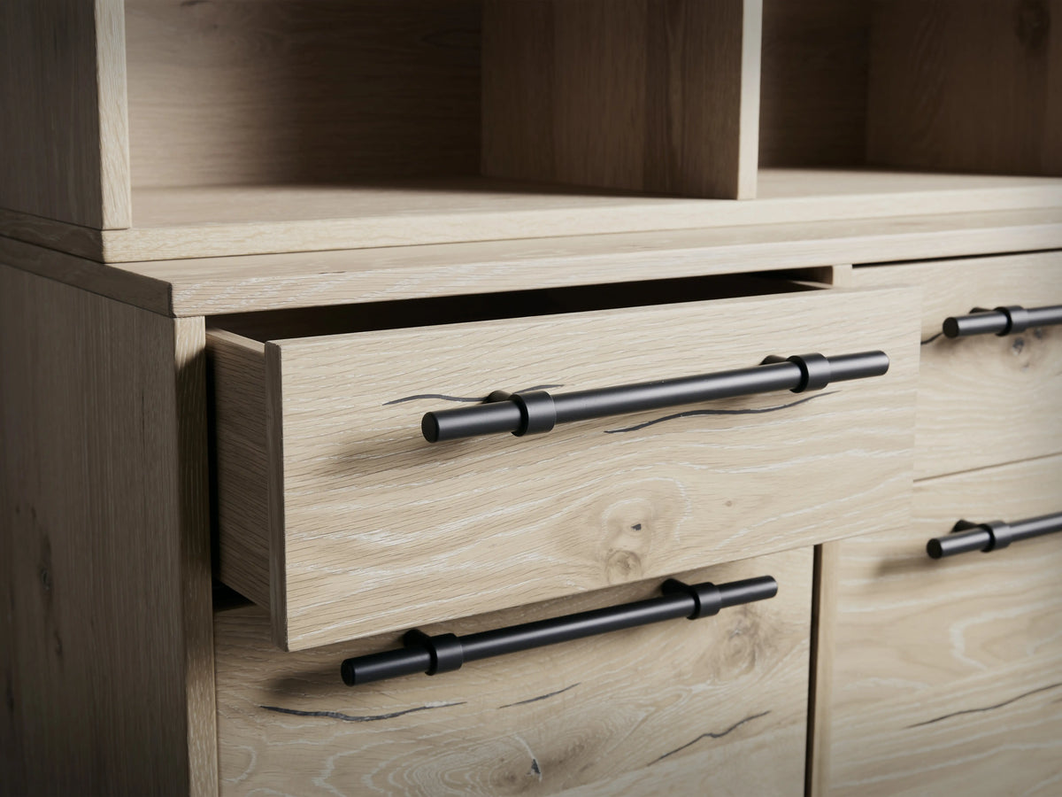 Sullivan Bookcase with File Base in light wood finish, featuring upper shelves and lower drawers with iron handles, on dark legs.
