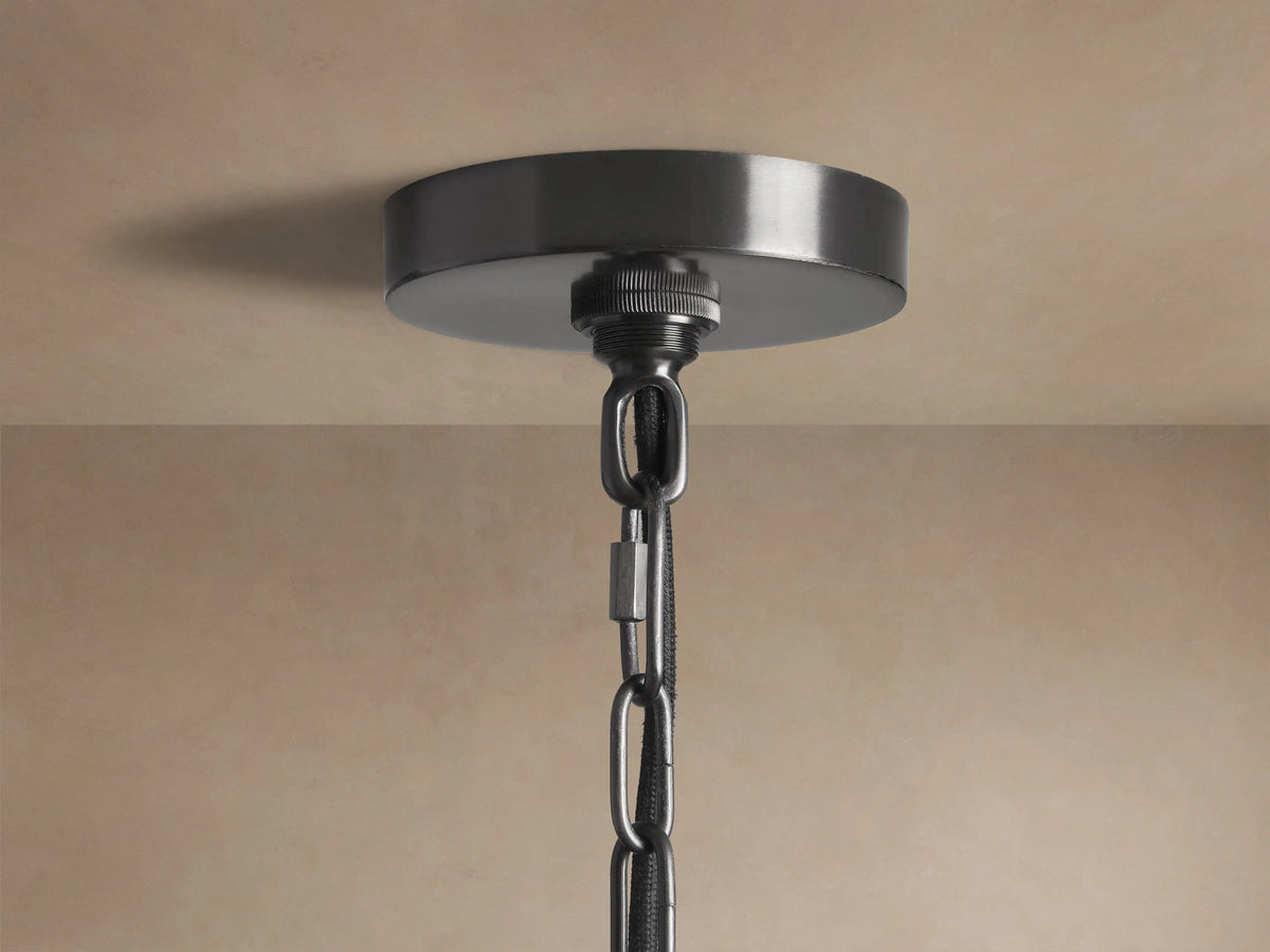 Close-up of Watley Dome Pendant with dark metallic exterior and polished antique brass interior.