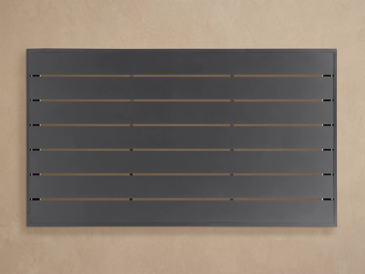 Angled close-up of a dark grey Bal Harbour Outdoor Aluminum Coffee Table, showing its slatted top and solid matte side panel.