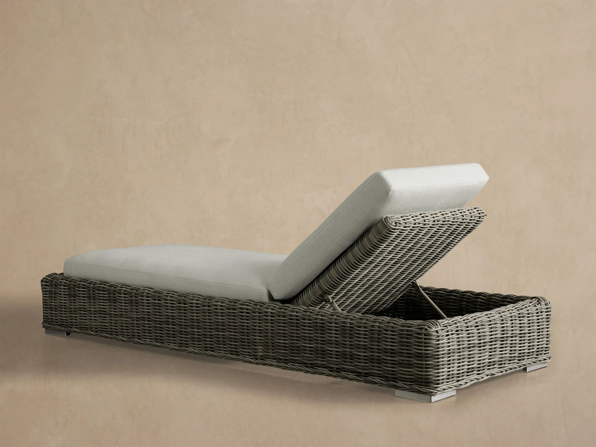 Close-up of the elevated gray woven backrest of the Montauk Outdoor Chaise with light gray cushion.