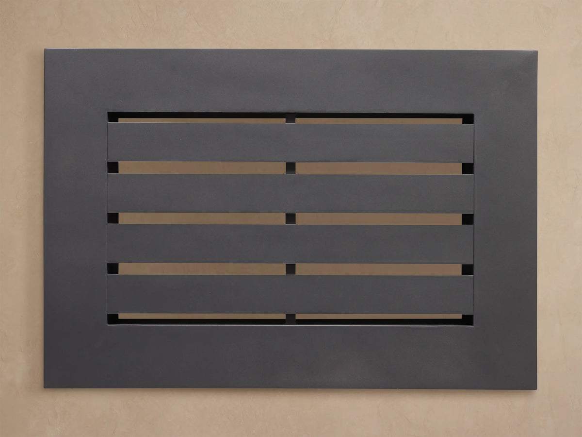 Close-up of Naxos Outdoor End Table. Smooth charcoal gray slatted top with an angular frame, viewed from the top corner.