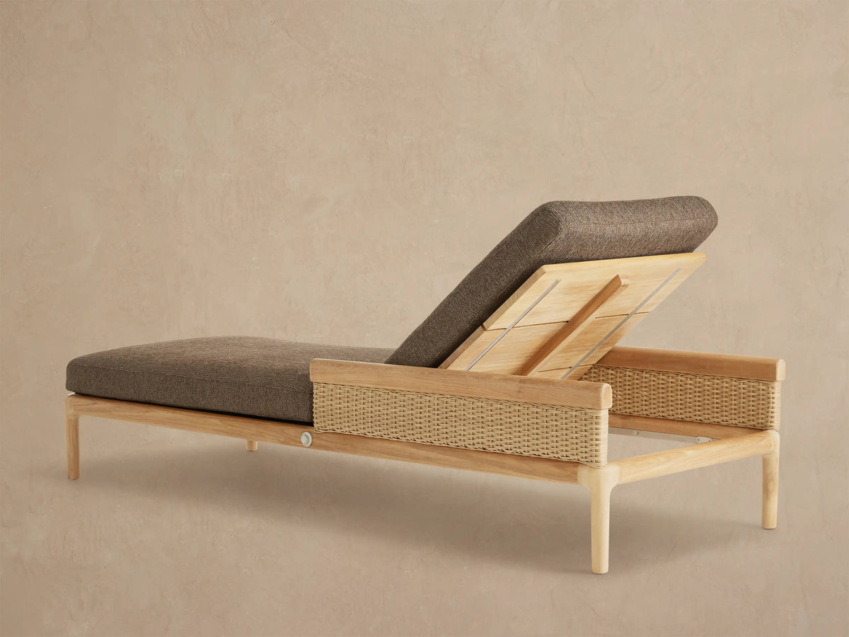 Puglia Outdoor Teak Chaise with natural teak frame, light woven side panel, and textured brown reclined cushion.