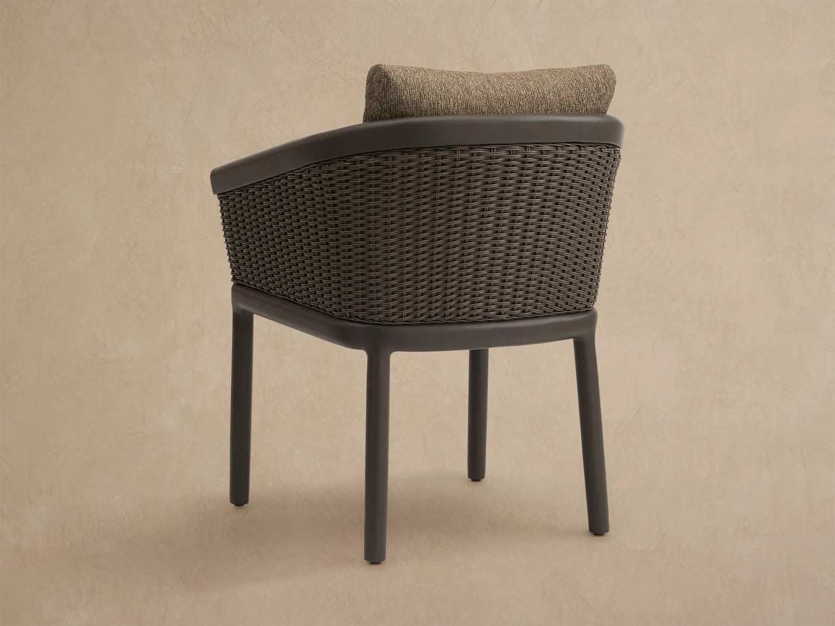 Close-up of Puglia Outdoor Aluminum Dining Chair with dark gray frame, brown woven resin wicker, and olive-brown cushions.