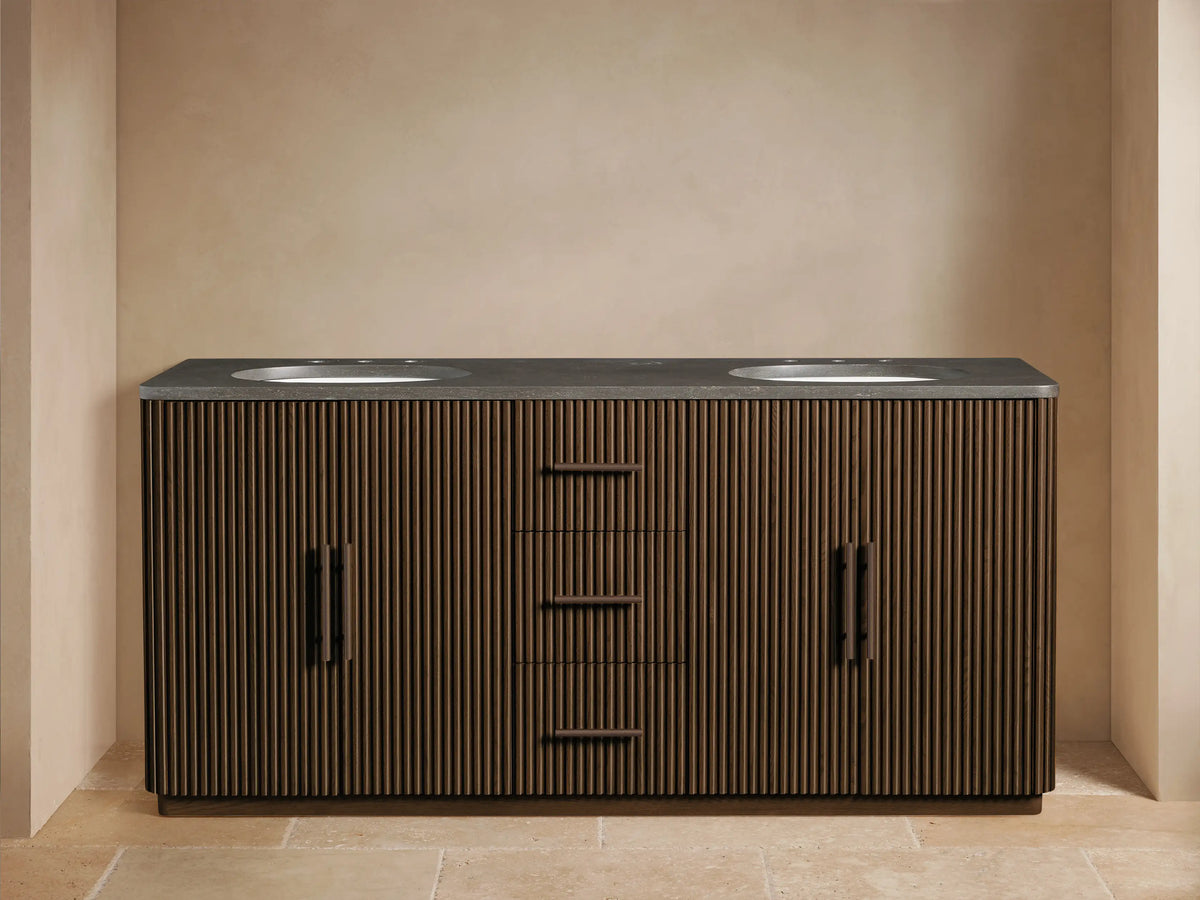 Close-up of Finnley Double Vanity in dark oak, ribbed. Drawer open, revealing white towels, with dark bronze bar handle.