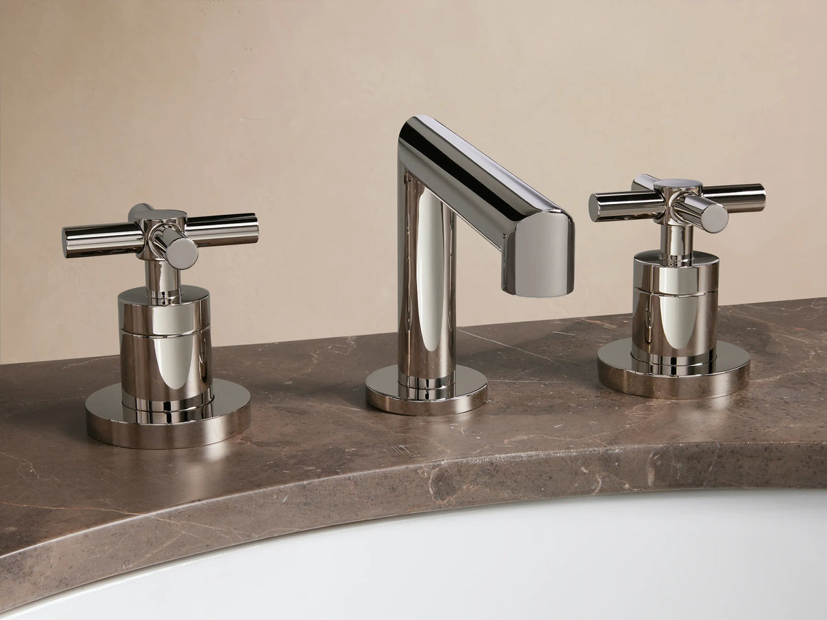 Lomas Faucet with polished nickel finish features a central spout with two cross-style handles, mounted on a beige countertop.