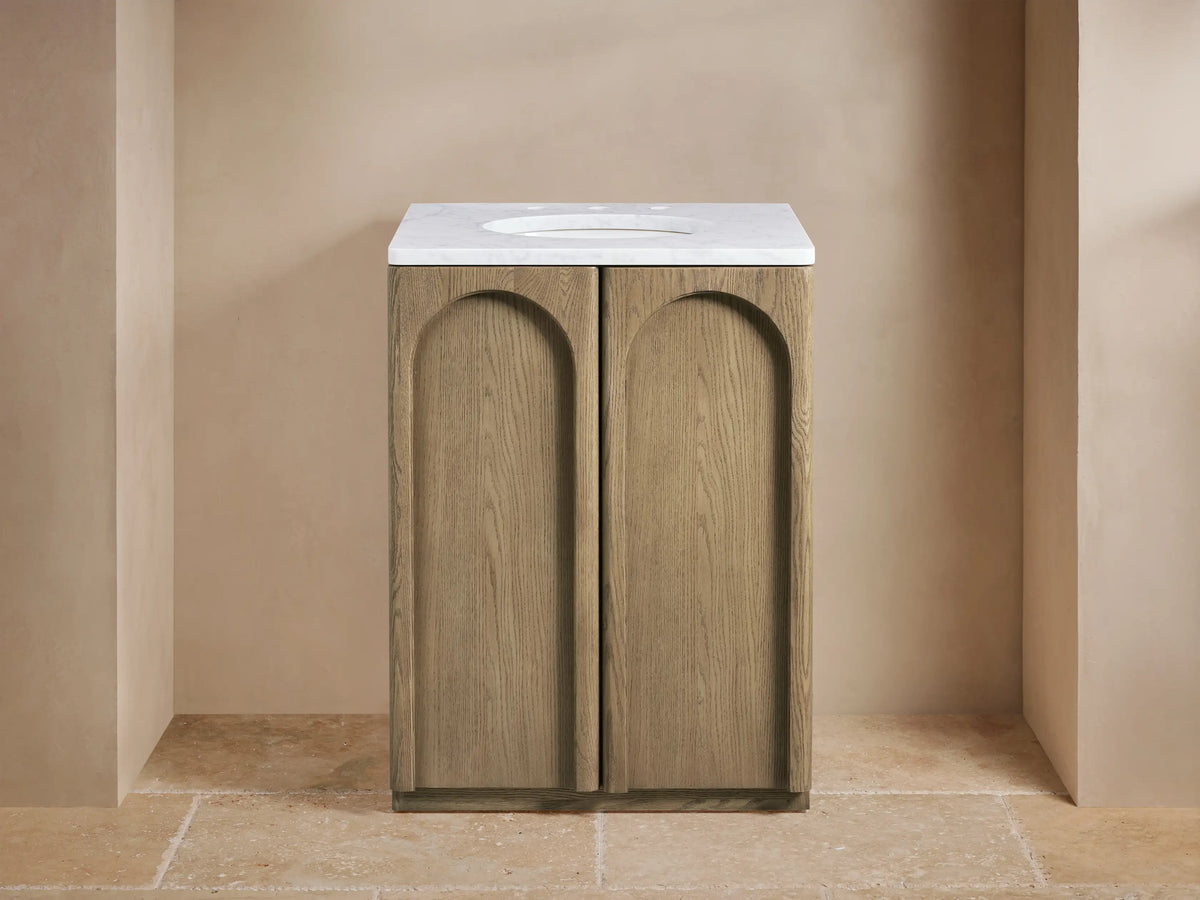 Provo Powder Vanity with oak wood finish, open door revealing shelves with towels, stone top visible.