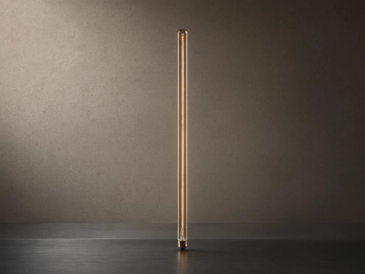 Side view of a slender, tubular light bulb with a glowing filament emitting a warm amber light and a screw-in base.