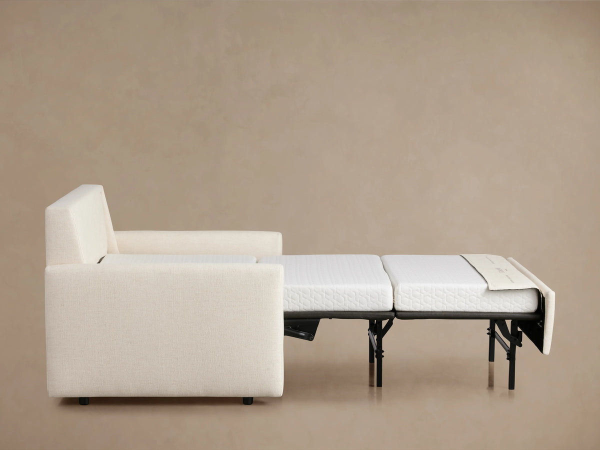 Kipton Slim Arm Luxury Twin Sleeper Chair in cream fabric, viewed from the back. Features slim arms and a plush backrest.