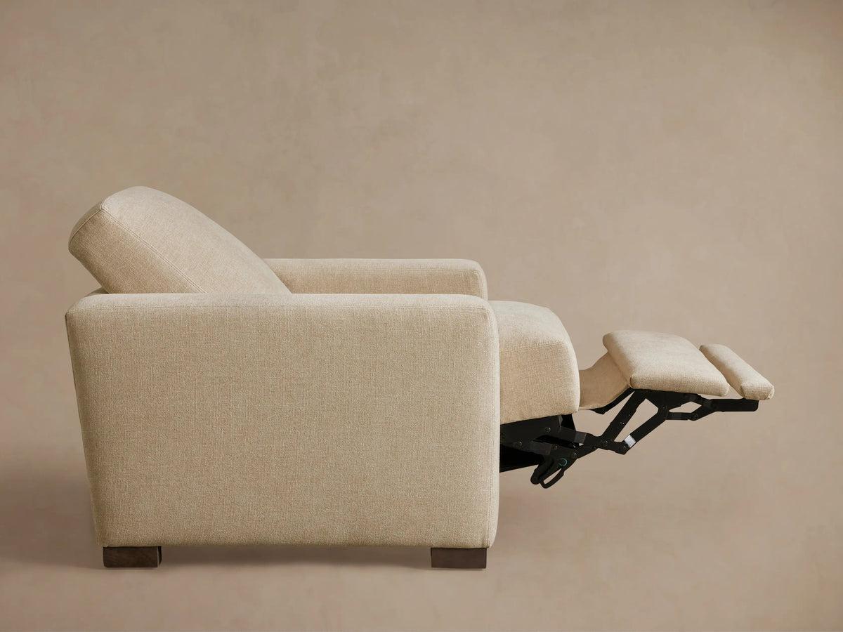 Front view of the light beige Remington Motion Recliner, upholstered in textured fabric, with its footrest partially extended.