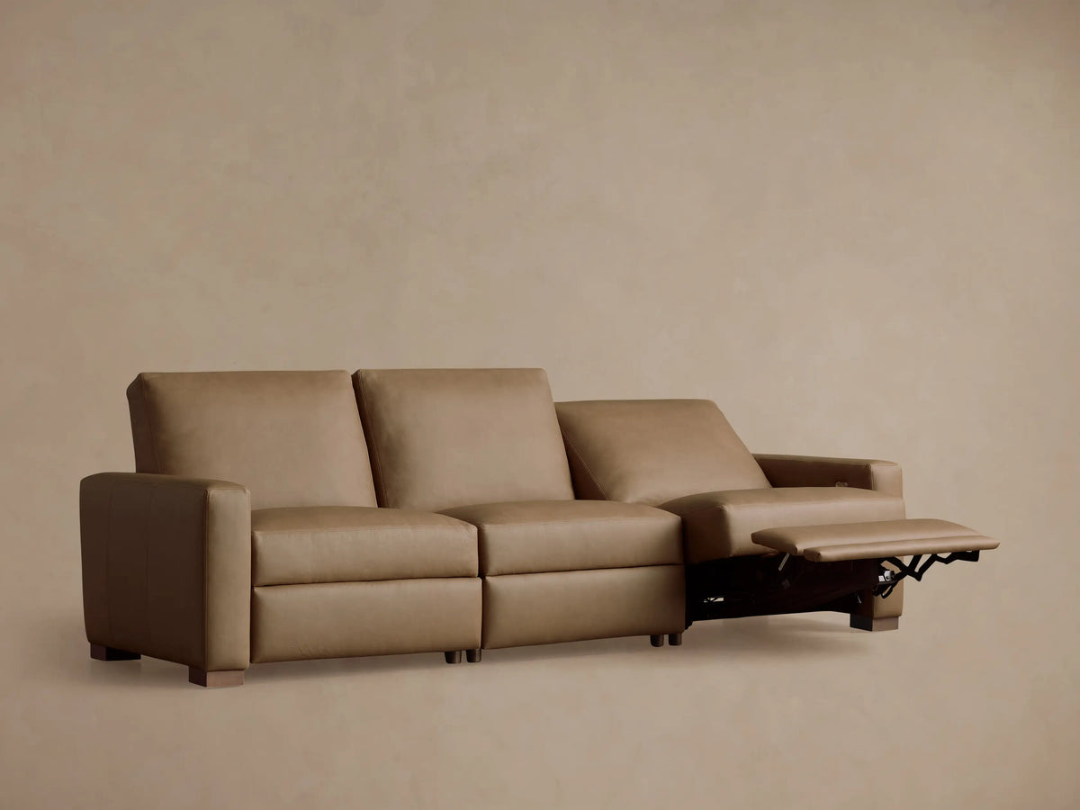 Remington Leather Three-Piece Motion Sofa in tan leather, with two right recliners partially extended, against a neutral tan wall.