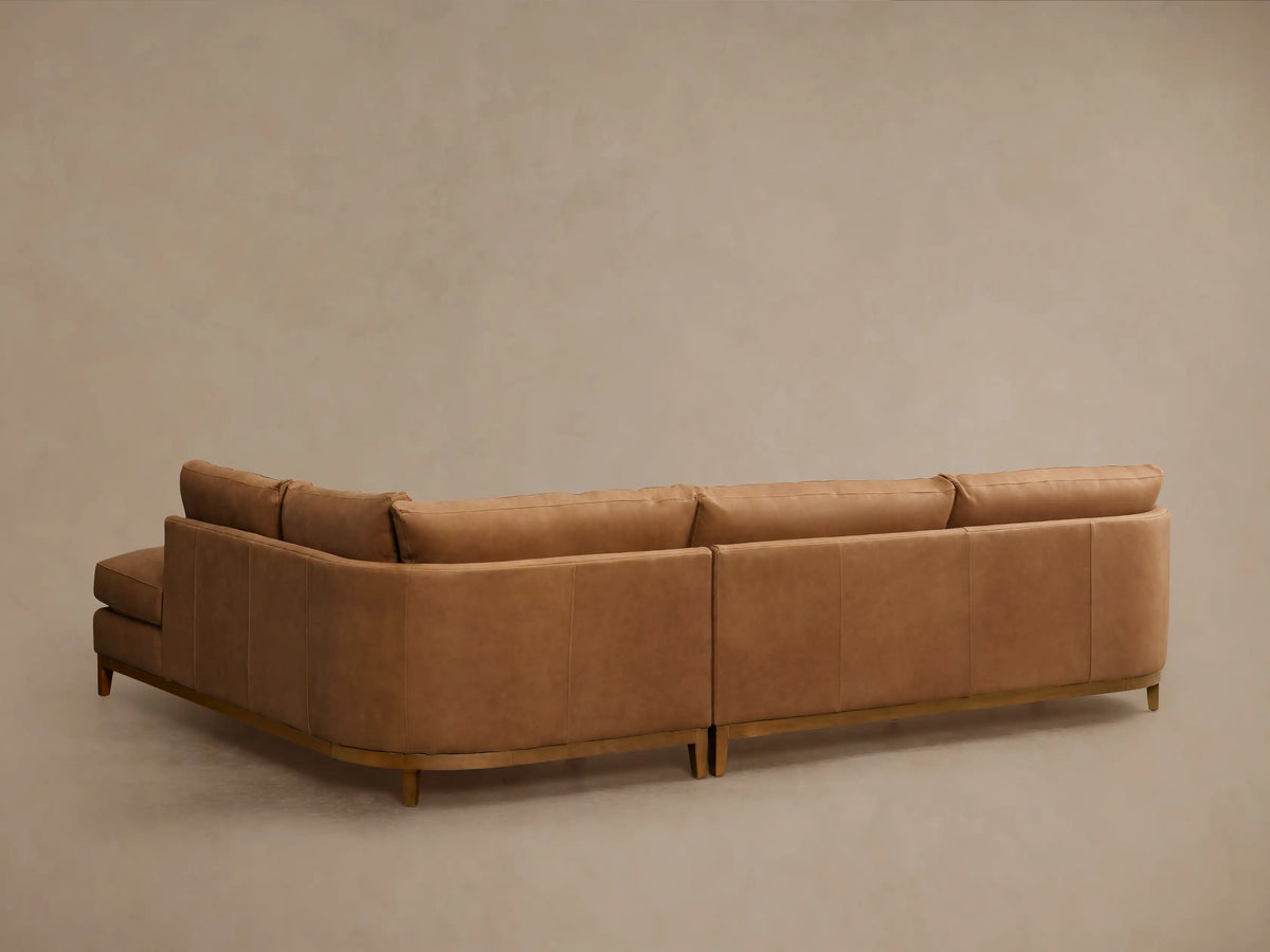 Bainbridge Leather Two-Piece Bumper Sectional close-up: supple tan leather, plush seat cushion, precise stitching, wooden base.