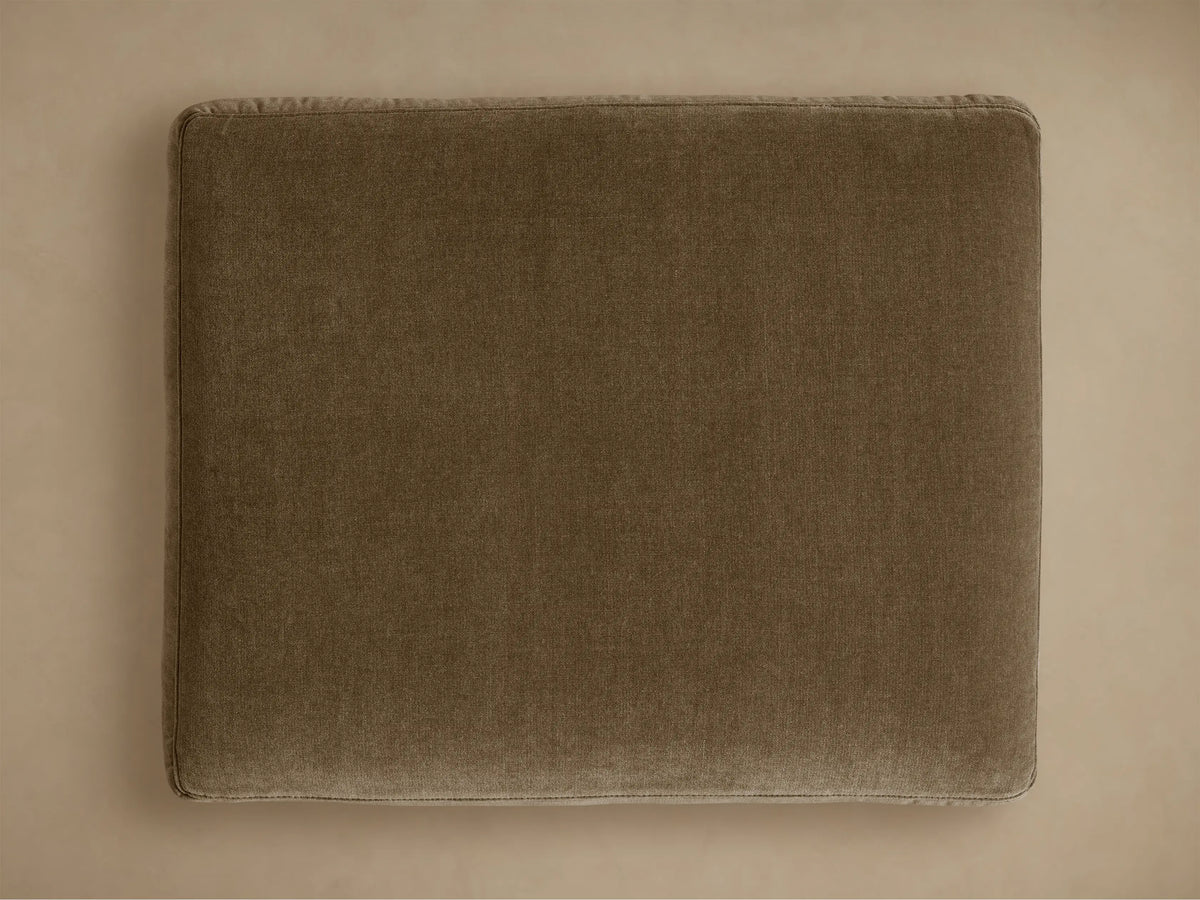 Close-up of the Bronte Ottoman cushion in a rich moss green, showcasing its plush, soft textured fabric and detailed stitching.