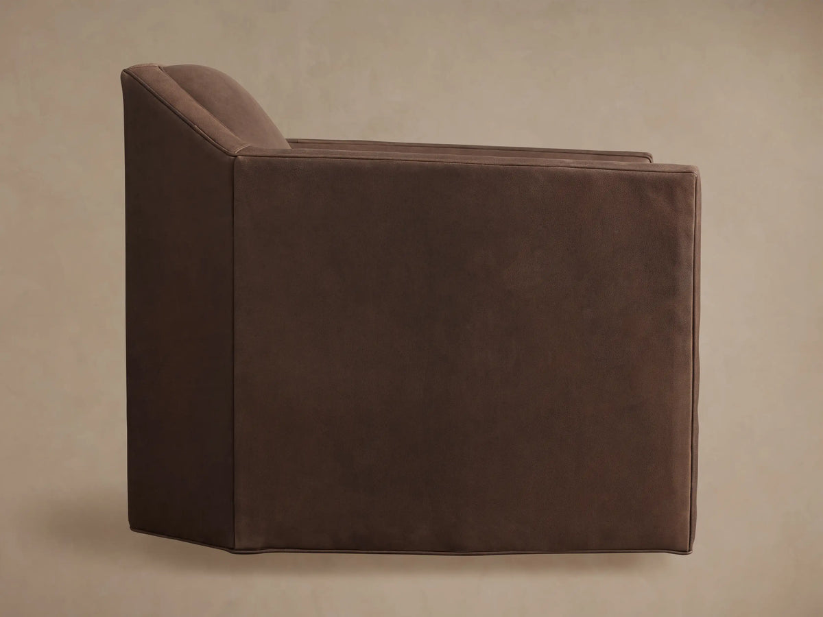 Angled rear view of the Marina Leather Swivel Chair, showcasing its geometric design in rich, variegated brown leather upholstery.
