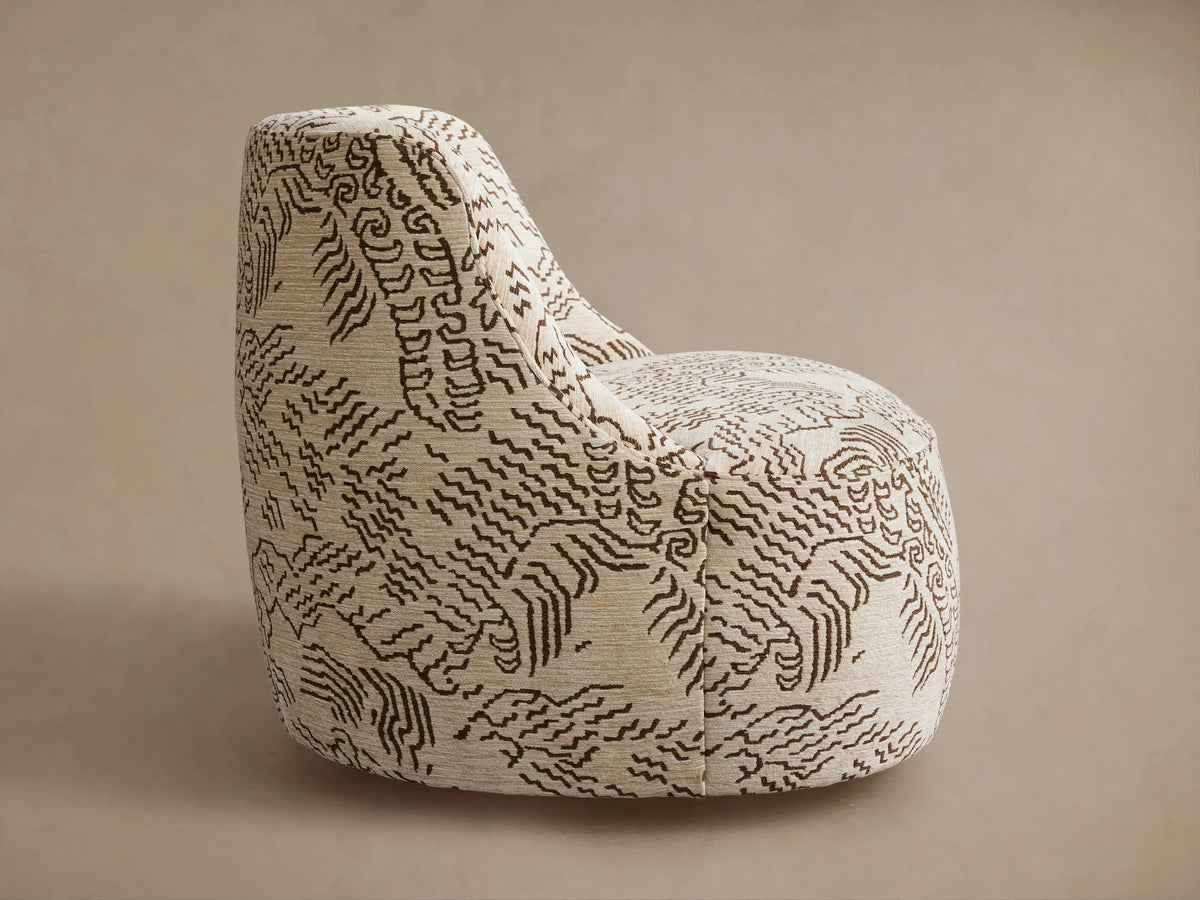 Sonny Swivel Chair: curved back, light beige fabric with an intricate dark brown organic pattern, seen from behind at an angle.