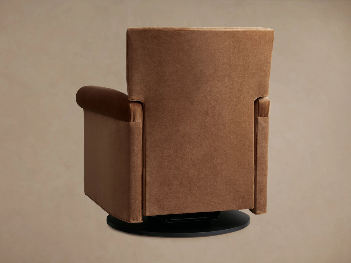 Rudy Rolled Arm Swivel Recliner in cognac velvet, side view. Reclined position showing cushioned seat, rolled arms, and swivel base.