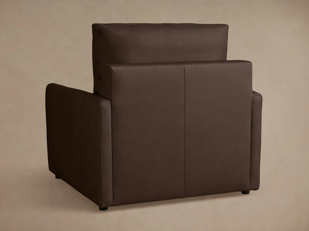 Kipton Leather Motion Recliner in brown leather, side view. Reclined position with extended footrest, slim arm design.
